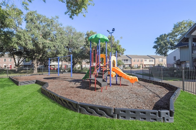 view of playground with a lawn