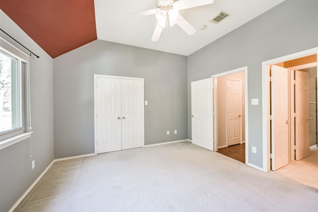 unfurnished bedroom with carpet, ceiling fan, and vaulted ceiling