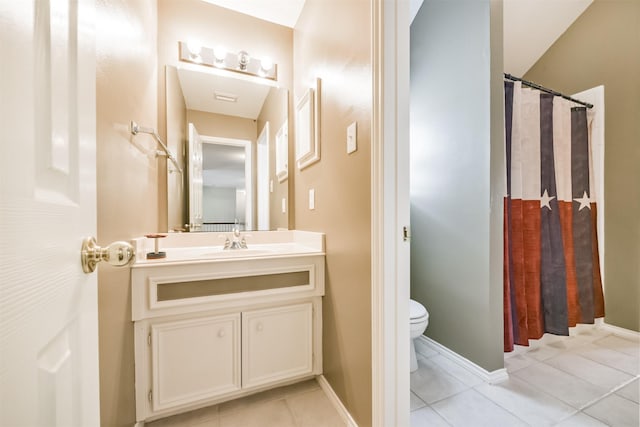 bathroom featuring tile patterned floors, vanity, curtained shower, and toilet