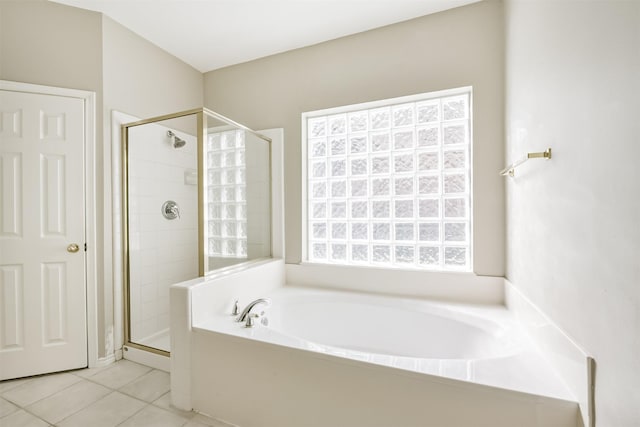 bathroom featuring tile patterned flooring and shower with separate bathtub