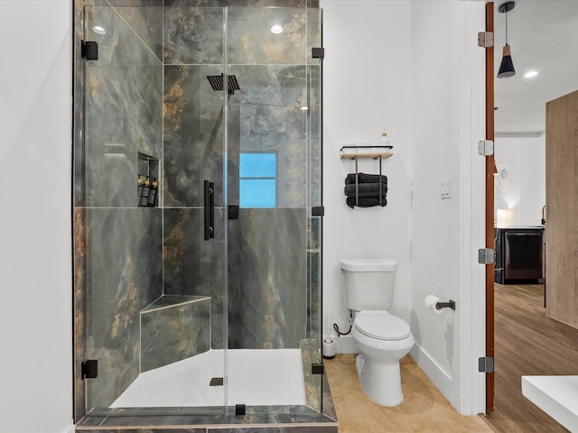 bathroom featuring walk in shower, tile patterned flooring, and toilet