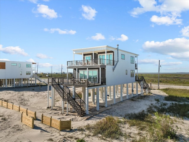 view of front of house featuring a rural view and a balcony