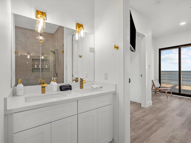 bathroom featuring vanity, a shower with shower door, and hardwood / wood-style flooring