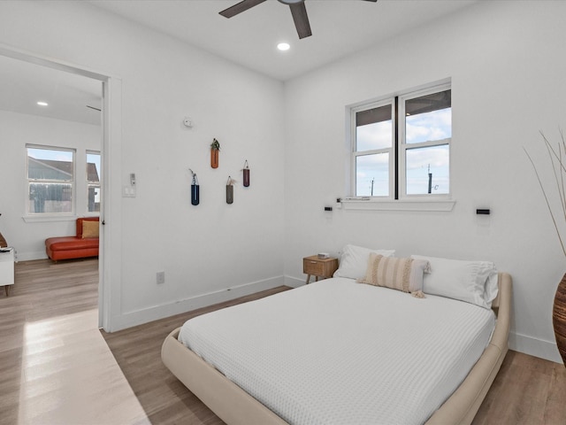 bedroom with ceiling fan and light hardwood / wood-style flooring