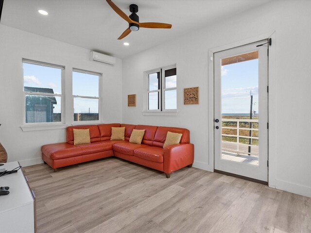 living room featuring a wealth of natural light and a wall mounted AC