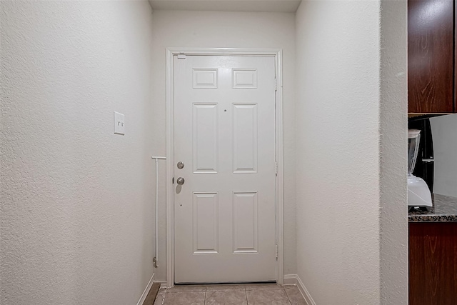 entryway with light tile patterned floors