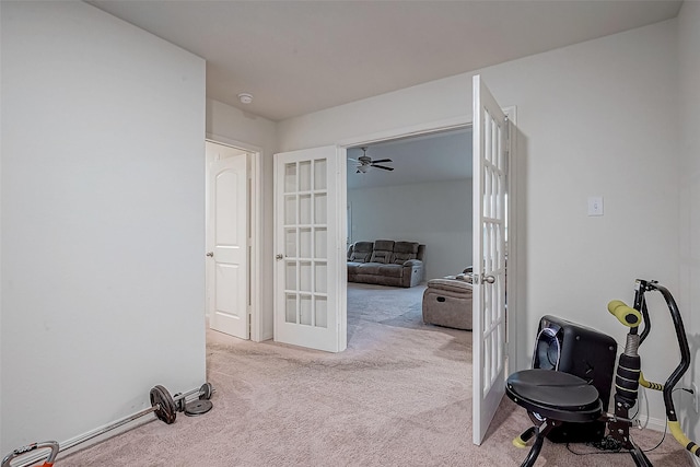 hall featuring light carpet and french doors