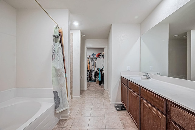 bathroom with plus walk in shower, tile patterned flooring, and vanity