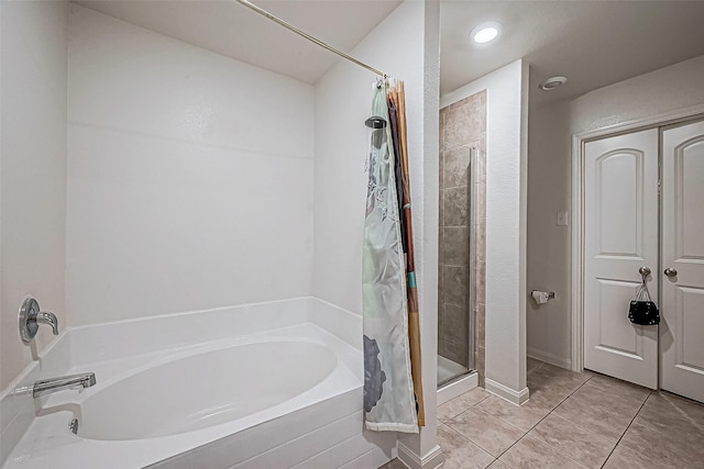 bathroom with plus walk in shower and tile patterned flooring