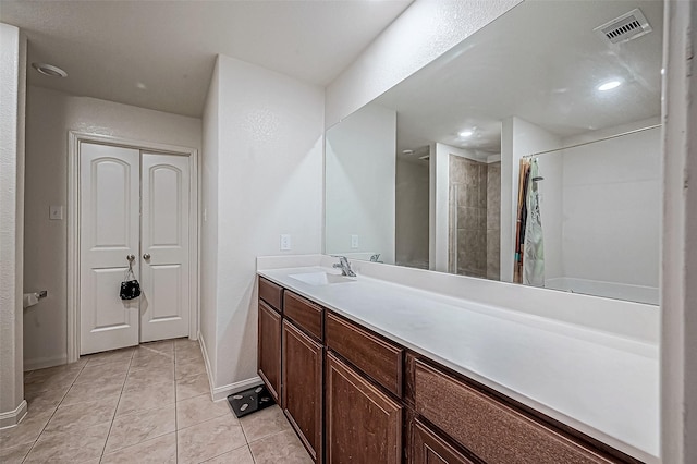 bathroom featuring tile patterned flooring, vanity, and a shower with shower curtain