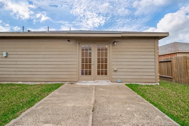 exterior space featuring french doors, a patio, and a lawn