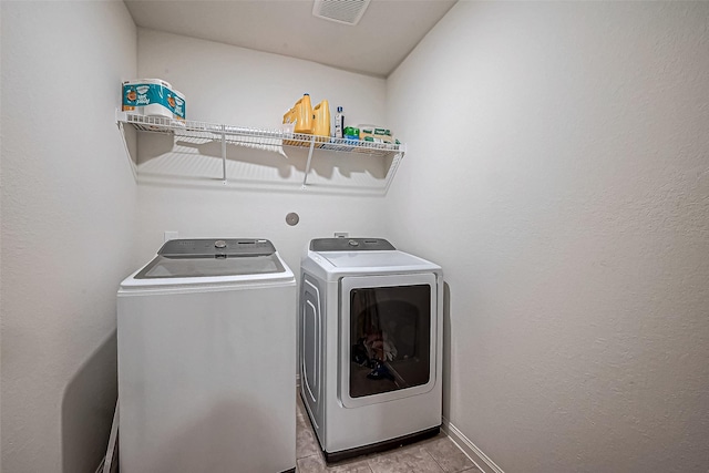 clothes washing area featuring separate washer and dryer