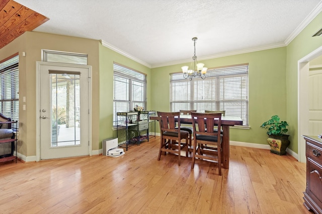 dining room featuring a chandelier, crown molding, and light hardwood / wood-style flooring