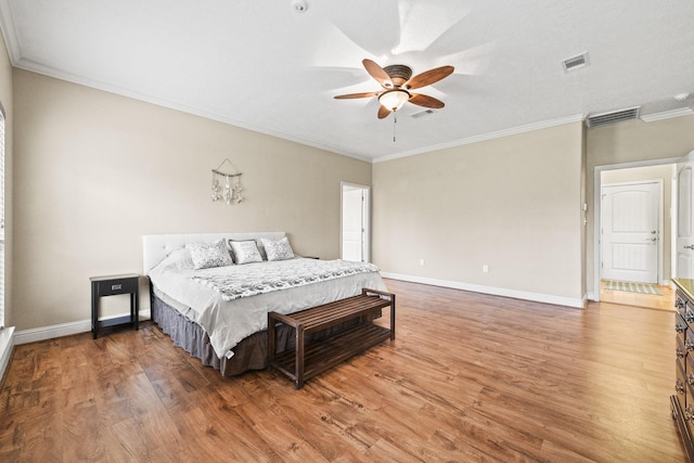 bedroom featuring dark hardwood / wood-style floors, ceiling fan, and ornamental molding