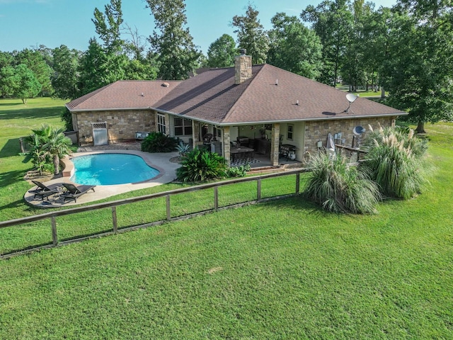 view of pool with a patio area and a lawn