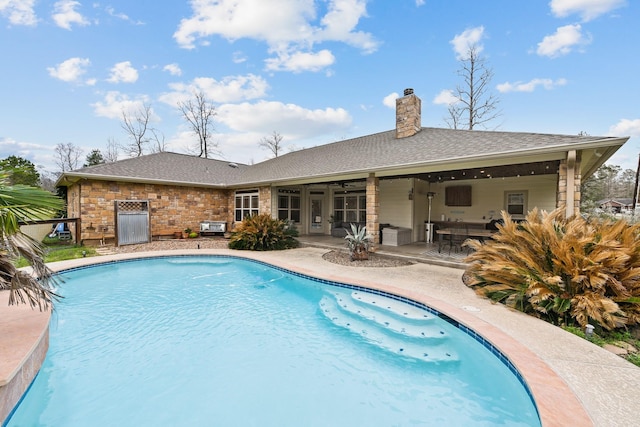 view of pool with ceiling fan and a patio