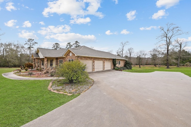 ranch-style home featuring a garage and a front lawn