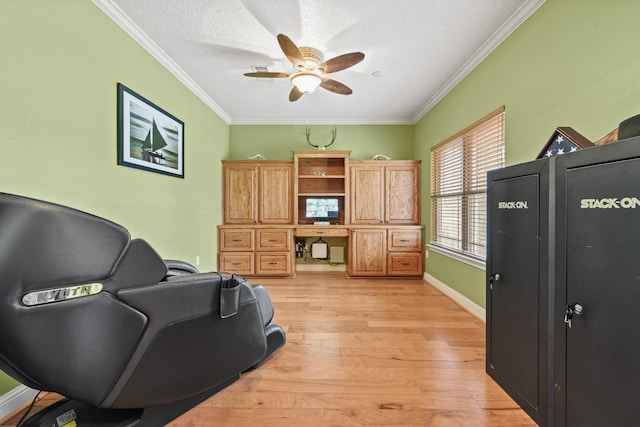 office area with ceiling fan, ornamental molding, and light wood-type flooring