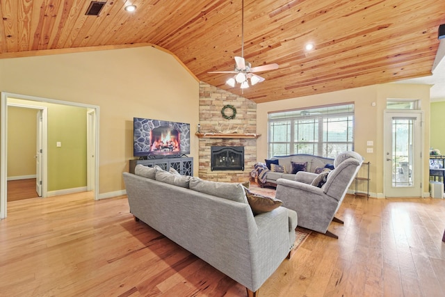 living room with light wood-type flooring, wood ceiling, ceiling fan, high vaulted ceiling, and a stone fireplace