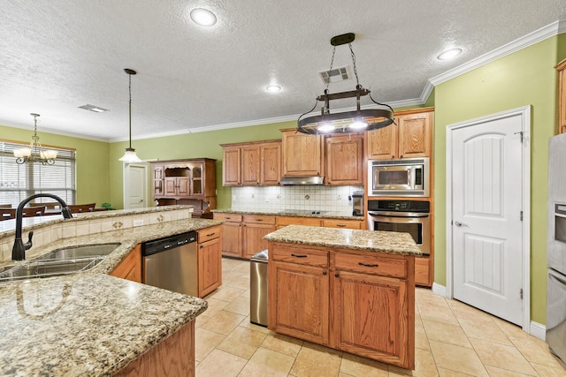 kitchen with sink, hanging light fixtures, a large island, stainless steel appliances, and a chandelier