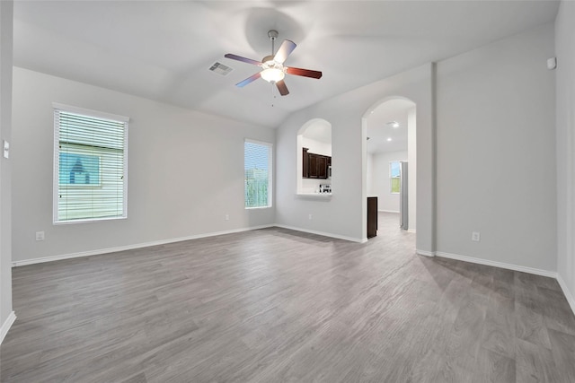 unfurnished living room with ceiling fan, hardwood / wood-style floors, and a healthy amount of sunlight