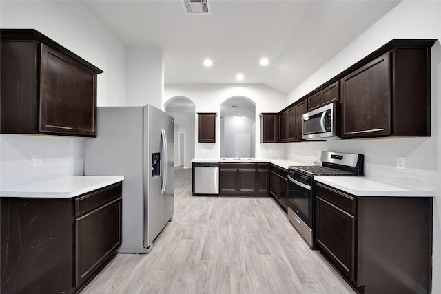 kitchen featuring light wood-type flooring, stainless steel appliances, dark brown cabinetry, and sink