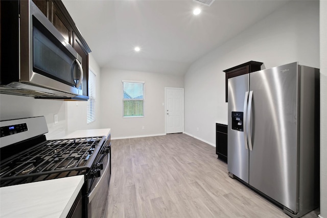 kitchen featuring light wood-type flooring, lofted ceiling, and appliances with stainless steel finishes