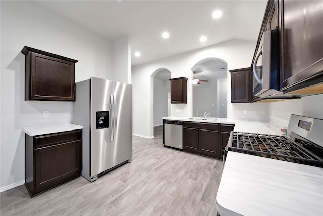 kitchen featuring light wood-type flooring, dark brown cabinetry, stainless steel appliances, ceiling fan, and sink