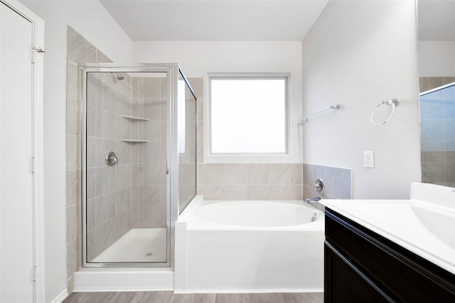 bathroom with vanity, shower with separate bathtub, and hardwood / wood-style flooring