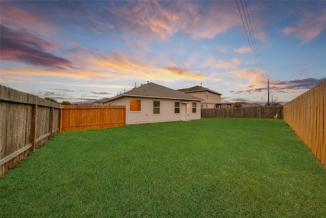 view of yard at dusk