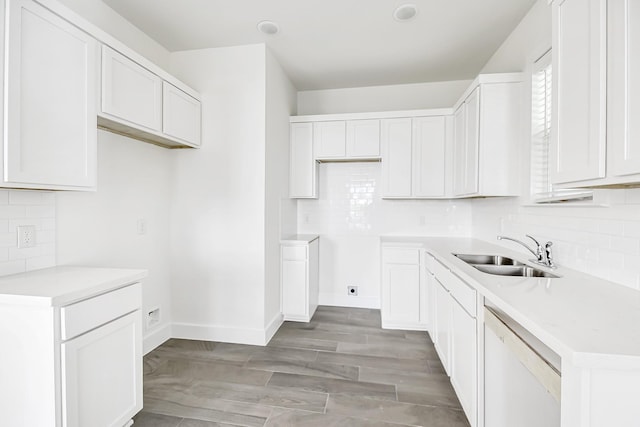 kitchen with sink, white cabinets, white dishwasher, and light wood-type flooring