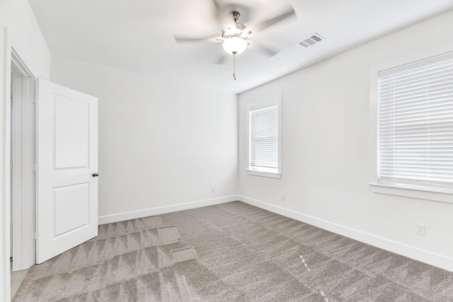 carpeted empty room featuring ceiling fan