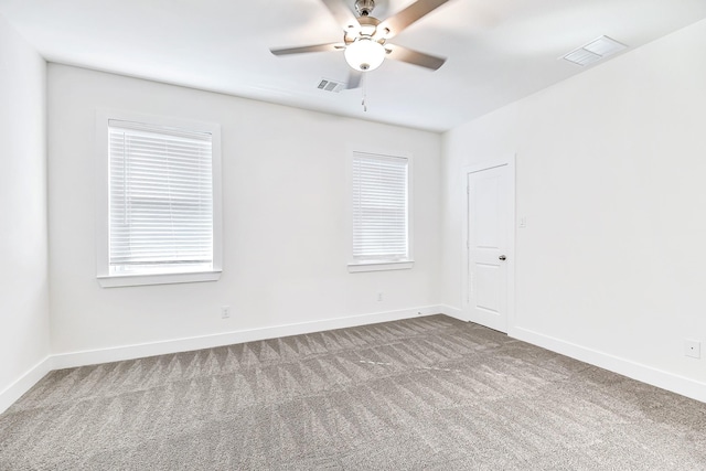 carpeted spare room featuring ceiling fan