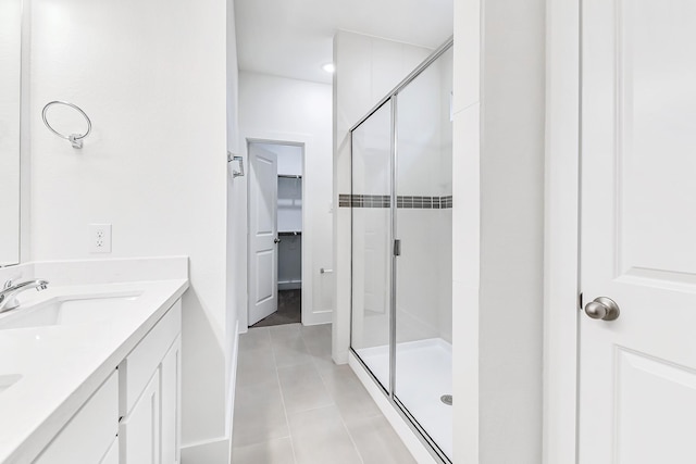 bathroom featuring vanity, tile patterned floors, and walk in shower