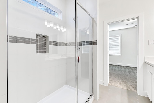 bathroom featuring tile patterned flooring, vanity, and an enclosed shower