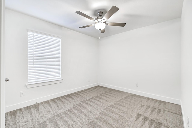 unfurnished room featuring ceiling fan and carpet