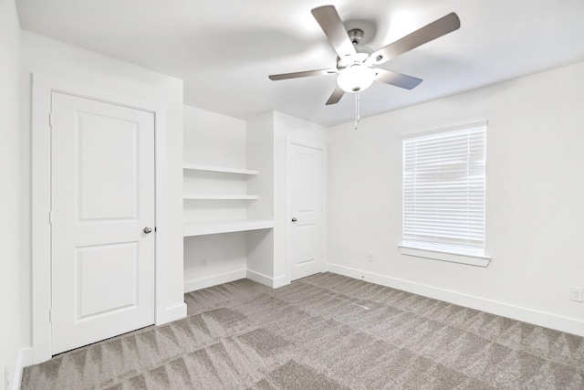 unfurnished bedroom featuring light colored carpet and ceiling fan