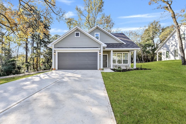 view of front of home with a front yard and a garage