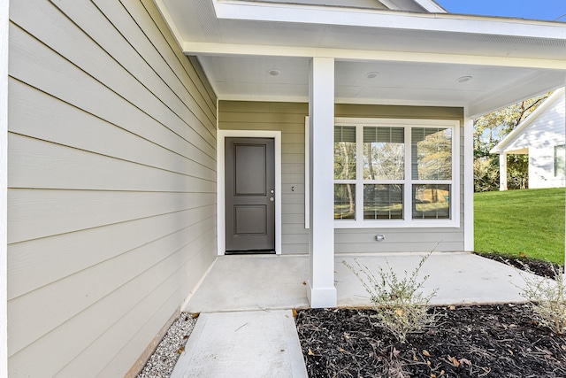 property entrance with a yard