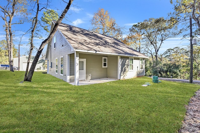 rear view of house with a yard and a patio