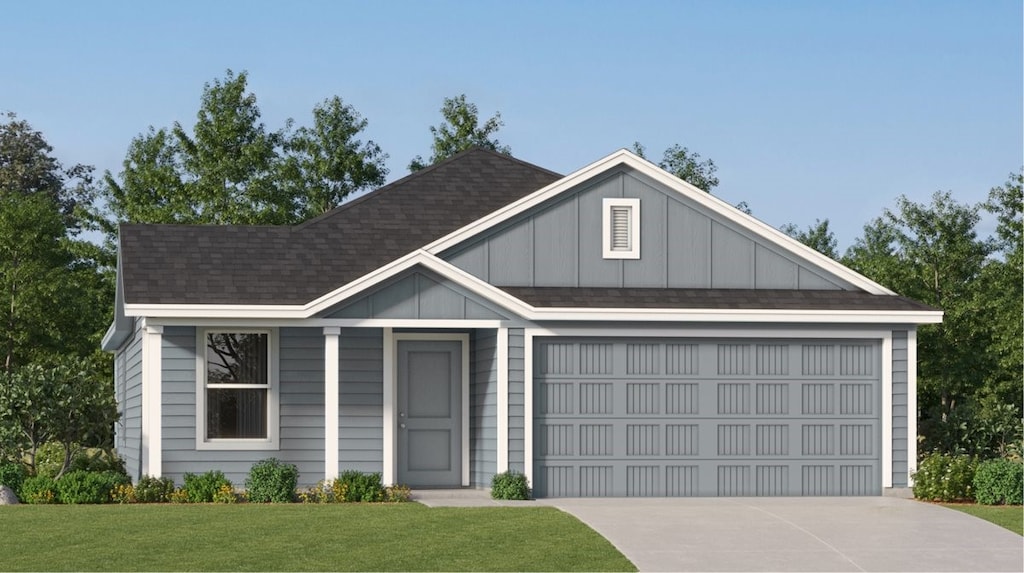 view of front of property featuring a garage and a front yard