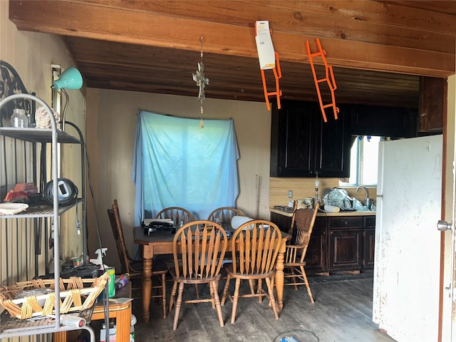 dining room with dark wood-type flooring and lofted ceiling