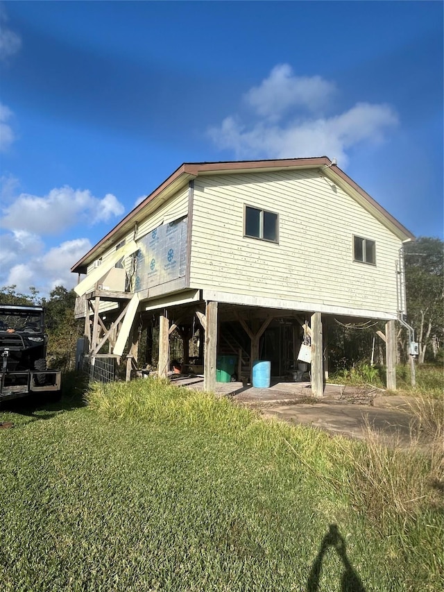 rear view of property featuring a yard