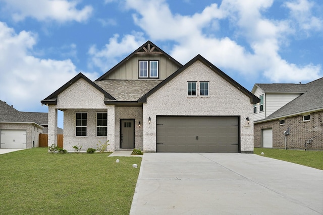 114 Little Spring Ct, Anahuac, TX 77514 - view of front of house featuring board and batten siding, driveway, a front lawn, a garage, and brick siding