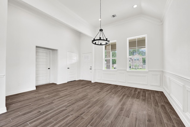 114 Little Spring Ct, Anahuac, TX 77514 - unfurnished dining area featuring a chandelier, dark wood-style flooring, crown molding, recessed lighting, and wainscoting