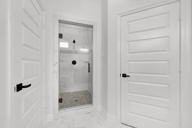 114 Little Spring Ct, Anahuac, TX 77514 - bathroom with marble finish flooring, baseboards, and a marble finish shower