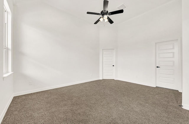 114 Little Spring Ct, Anahuac, TX 77514 - empty room featuring carpet flooring, ceiling fan, baseboards, and a towering ceiling