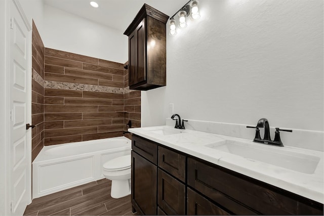 114 Little Spring Ct, Anahuac, TX 77514 - full bath with wood finished floors, toilet, double vanity, and shower / tub combination