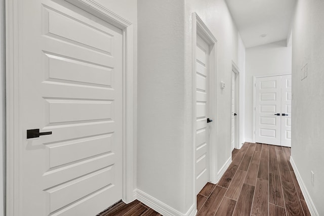 114 Little Spring Ct, Anahuac, TX 77514 - hallway with dark wood-style floors and baseboards