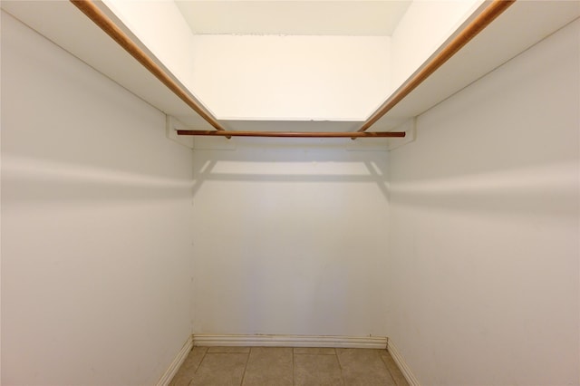 walk in closet with tile patterned floors